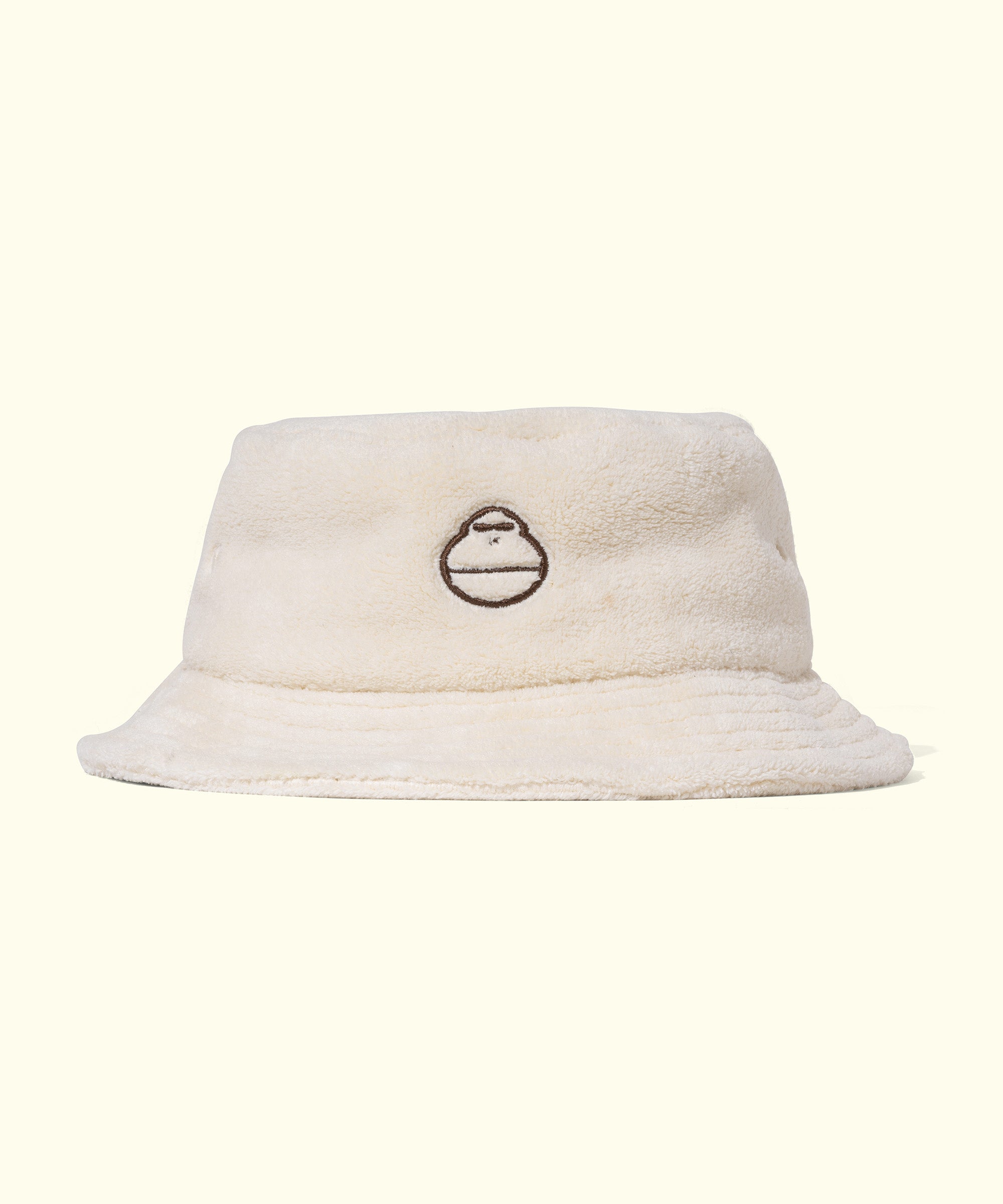 Cozy white plush bucket hat with embroidered logo on the front, perfect for stylish sun protection anywhere, by Sun Bum.