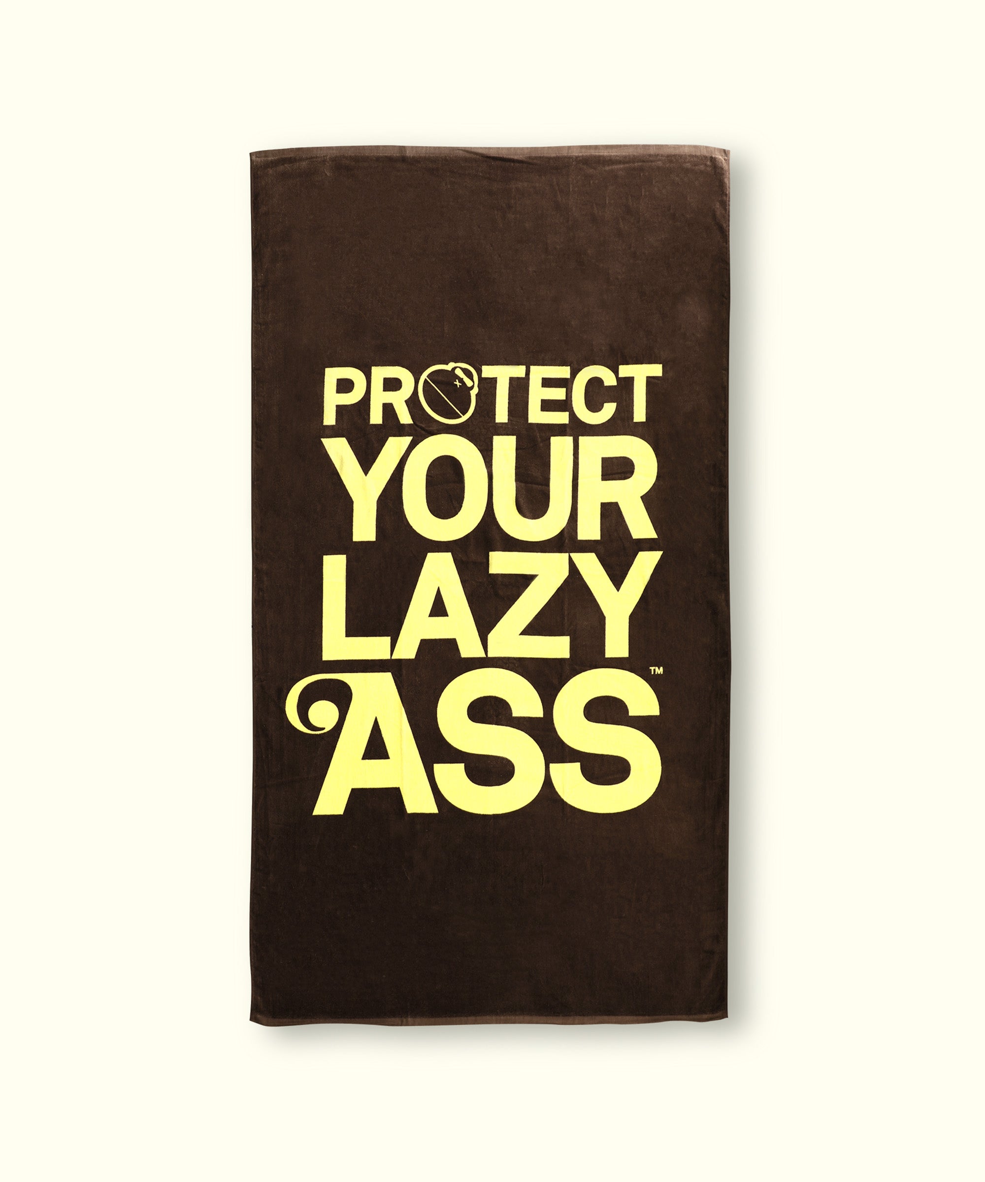 Brown 'PYLA' beach towel with bold yellow text reading "PROTECT YOUR LAZY ASS." by Sun Bum