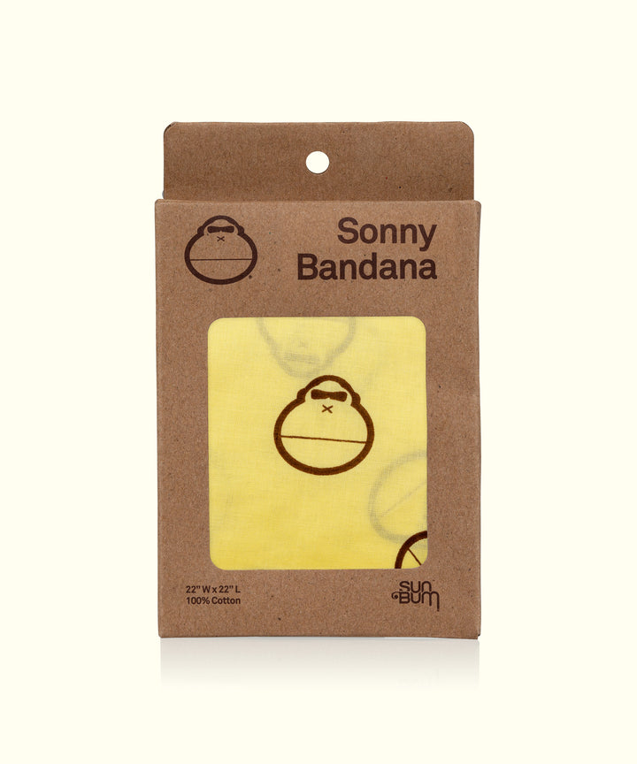 Yellow Sonny Bandana in eco-friendly packaging, featuring a cute monkey logo, versatile for headwear, neck protection, or bib, brought to you by Sun Bum.