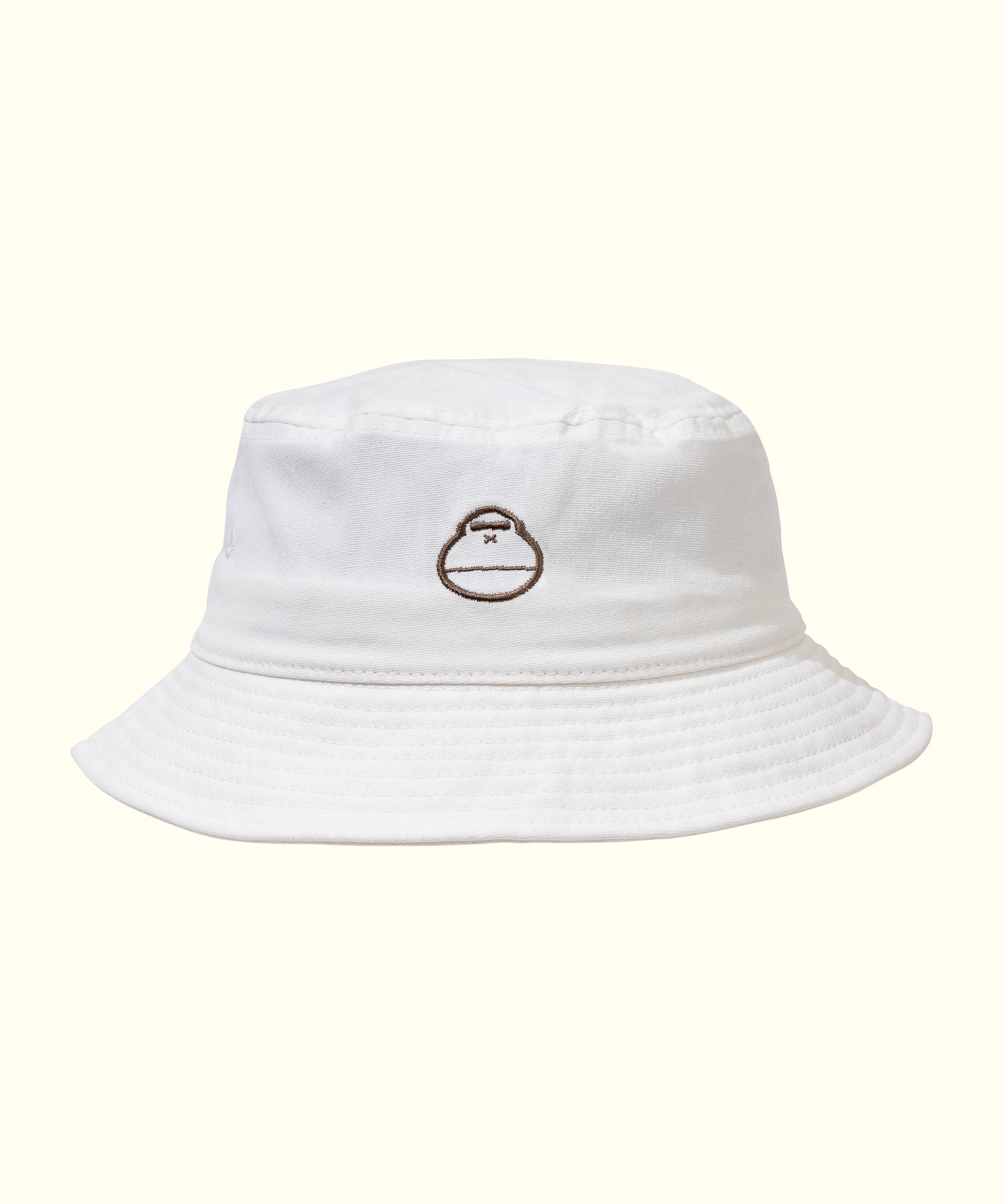 White bucket hat featuring a relaxed, comfy fit, perfect for the beach or streetwear. Sun Bum.