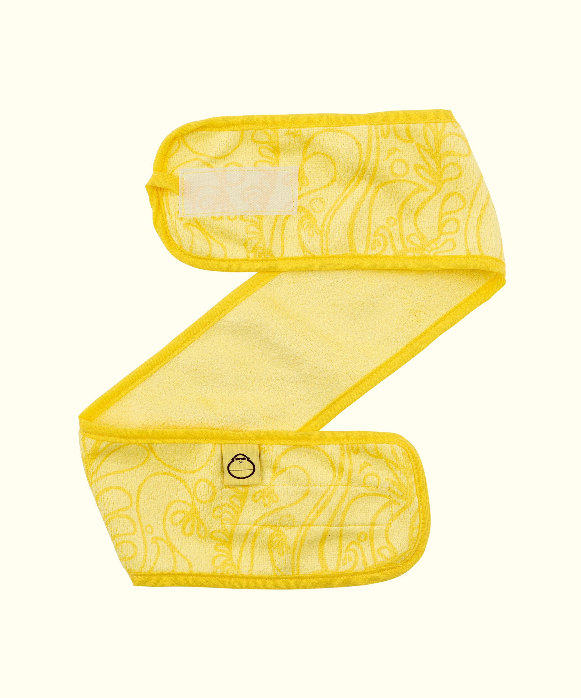 Yellow skin care headband designed to keep hair back during face washing, made from super soft fabric, perfect for daily skin care routines, Sun Bum.