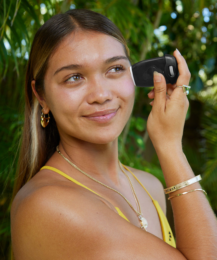 Woman applying Signature SPF 30 Sunscreen Face Stick outdoors, enjoying the sun safely with mineral-based protection. Sun Bum