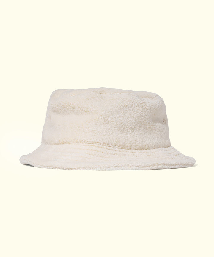 Soft and cozy off-white plush bucket hat perfect for style and sun protection. Sun Bum.