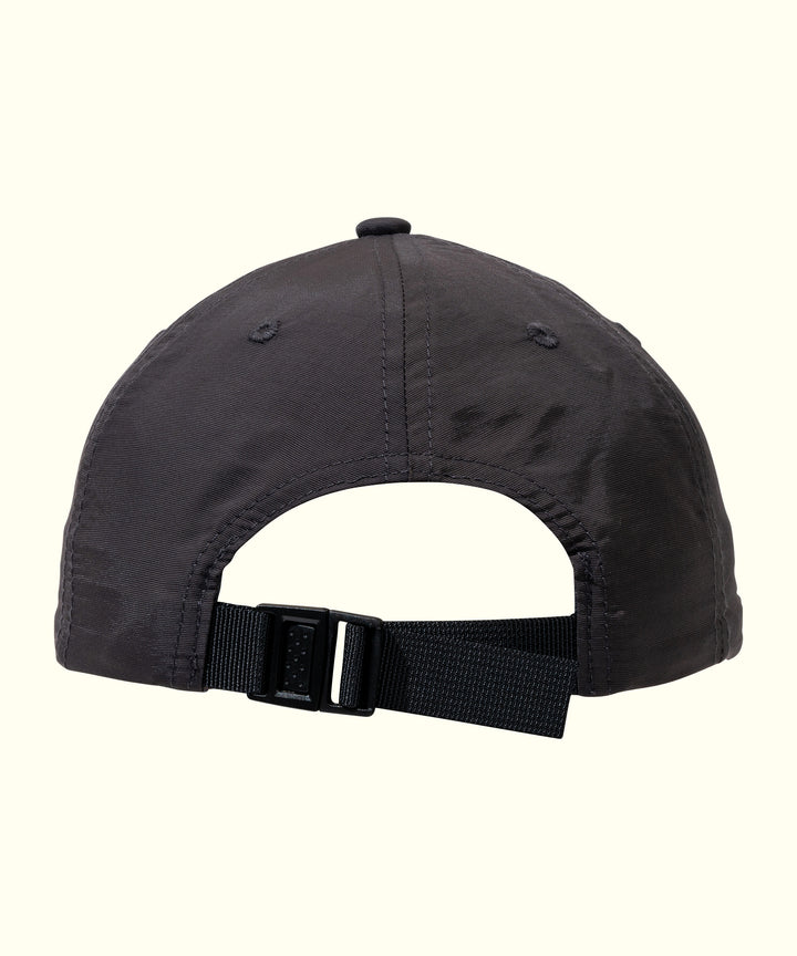 Back view of a black travel hat with an adjustable strap, classic and versatile design for everyday wear. Sun Bum.