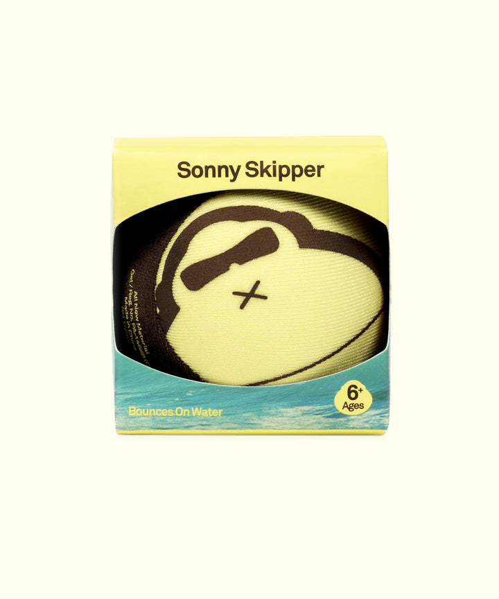 Yellow Sonny Skipper ball in package with fun skull design, perfect for ages 6 and up, bounces on water, Sun Bum, 