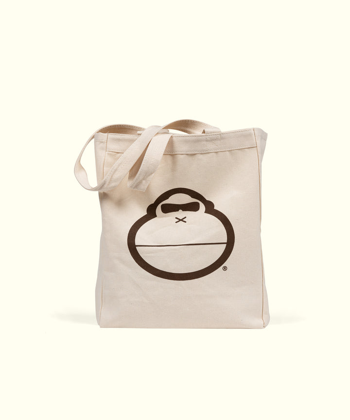 Canvas tote bag with a brown monkey face logo, perfect for daily use, Sonny Tote Bag by Sun Bum.