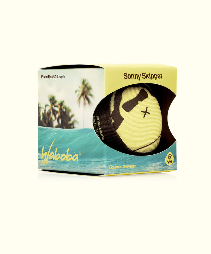 Yellow Sonny Skipper ball by Waboba in packaging, designed for ages 6 and up, with tropical-themed background. Fun water play toy, Sun Bum,