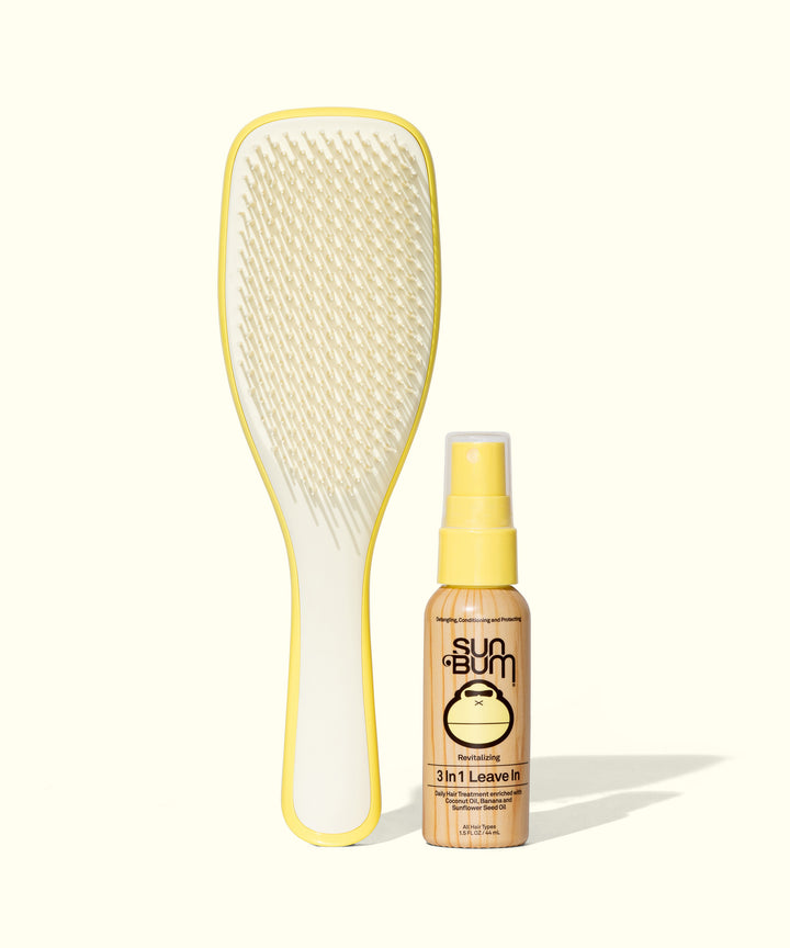 Ultimate hair care duo: white detangling brush with yellow trim and Sun Bum 3-in-1 Leave In conditioning spray bottle, perfect for on-the-go hair protection and styling. Sun Bum