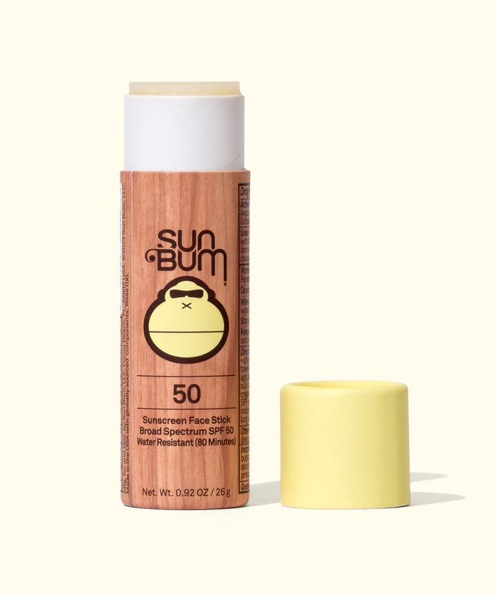 Paper Tube SPF 50 Sunscreen Face Stick by Sun Bum, featuring a wooden-textured tube with cap removed, designed for convenient on-the-go skin protection.